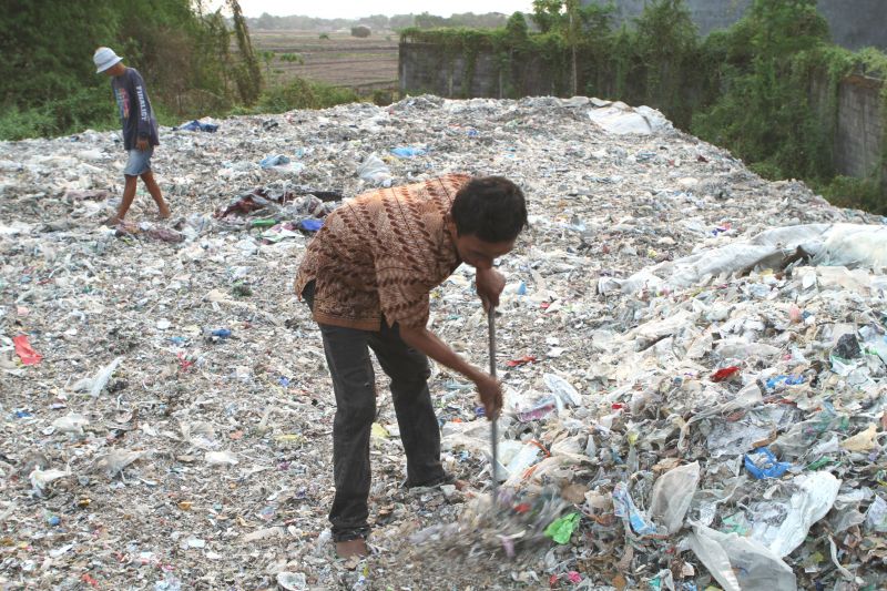 Man picking through plastic waste in Surabaya