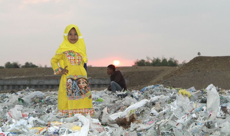 Child on a plastic waste dump, Surabaya, Indonesia