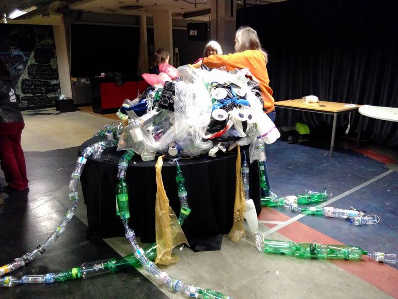Shoppers help to build a sea monster from plastic waste