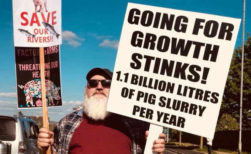 Protestor against Limavady pig farm with beard, sunglasses and banners.