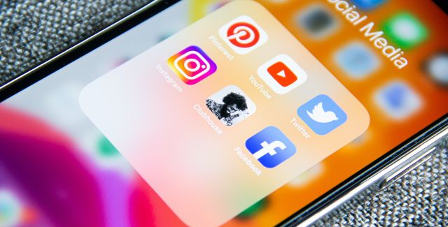 An apple iPhone zoomed in on social media apps Pintrest, YouTube, Twitter, Instagram, Clubhouse, Facebook
