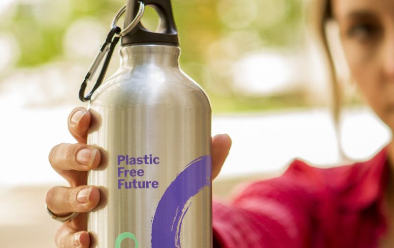 Close-up of woman holding Friends of the Earth Plastic-Free aluminium water bottle