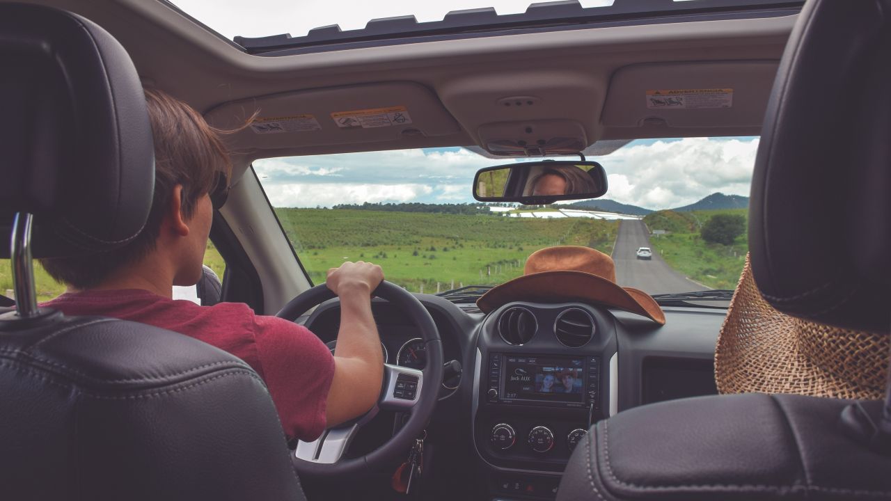 Man driving car with passenger