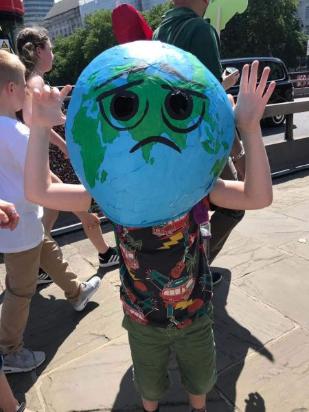 Alfie wearing an adult-sized Earth head