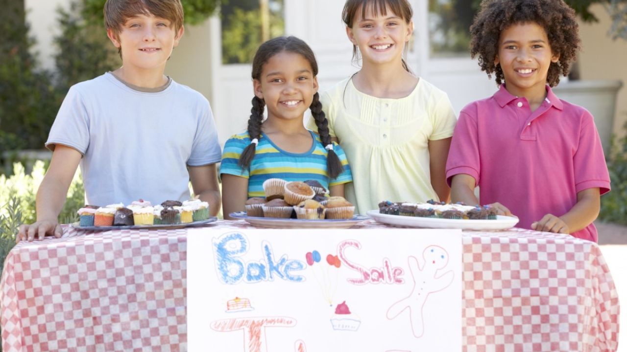 4 children running a cake stall