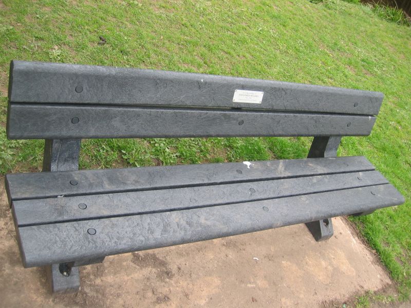 A bench made from old plastic bags in park or similar area