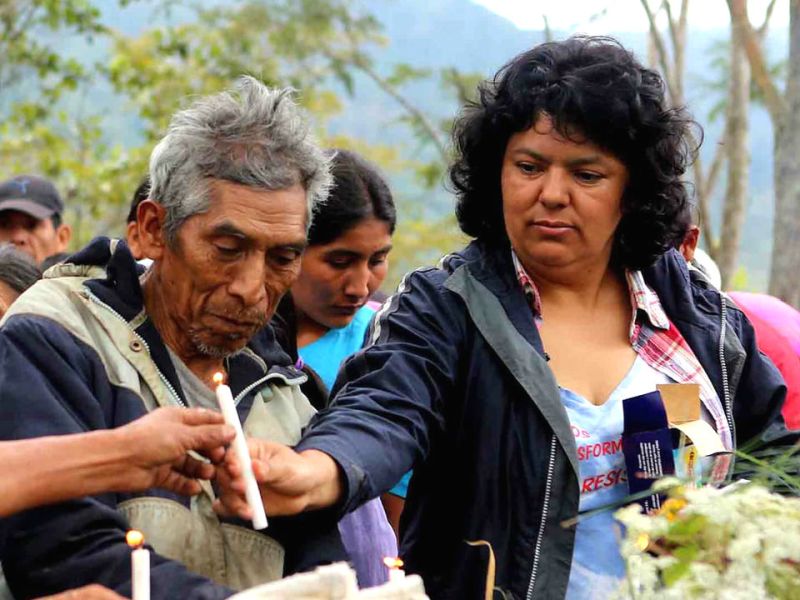 The late Indigenous activist Berta Cáceres handing out a candle to a fellow peaceful protestor