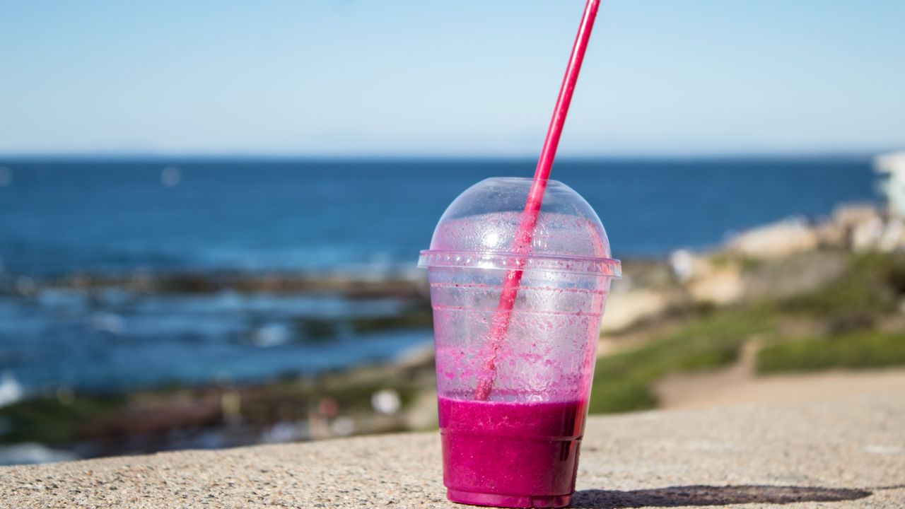 photo of smoothie in plastic cup with lid and straw