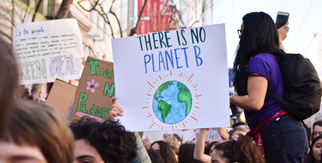 Placard reading 'There is on Planet B' in a crowd of people at a protest