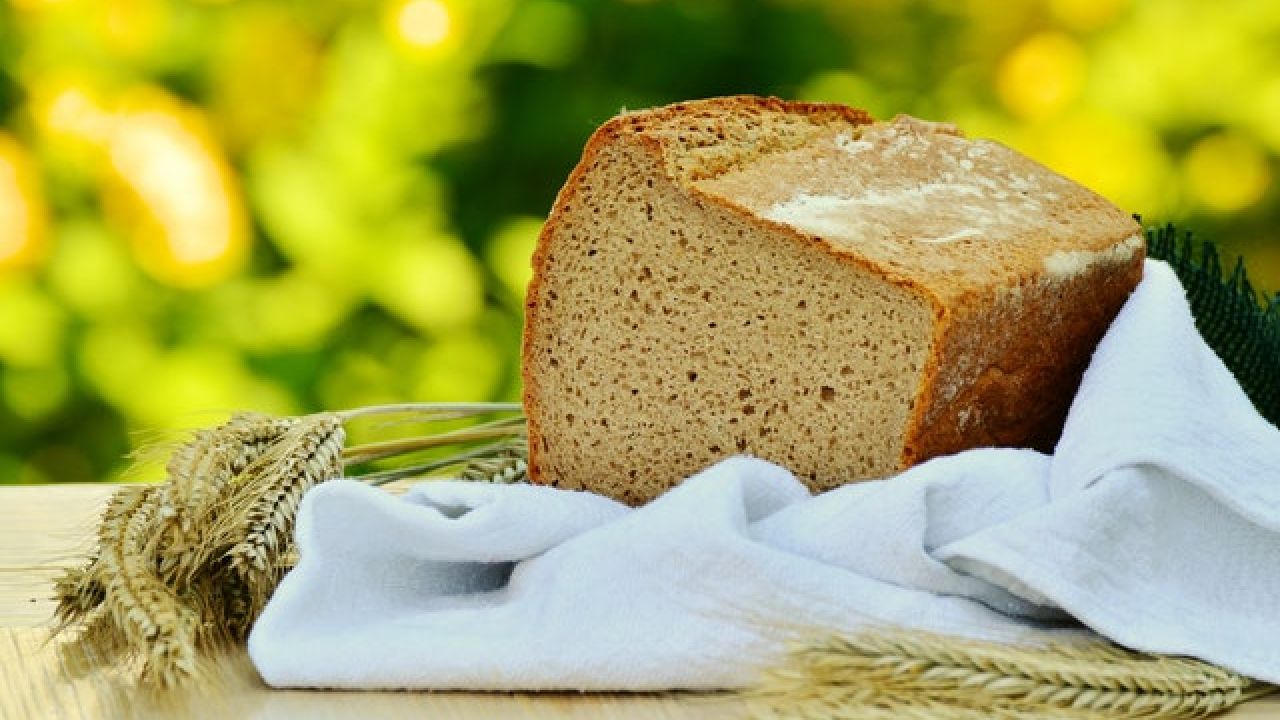 Loaf of bread on a teatowel on a table