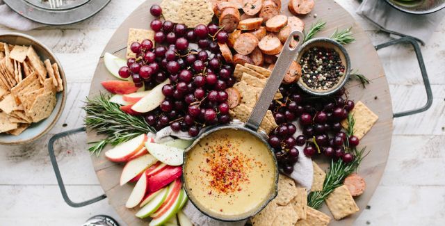 Platter of fruit, crackers and cheese.