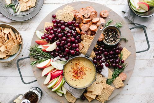Platter of fruit, crackers and cheese.