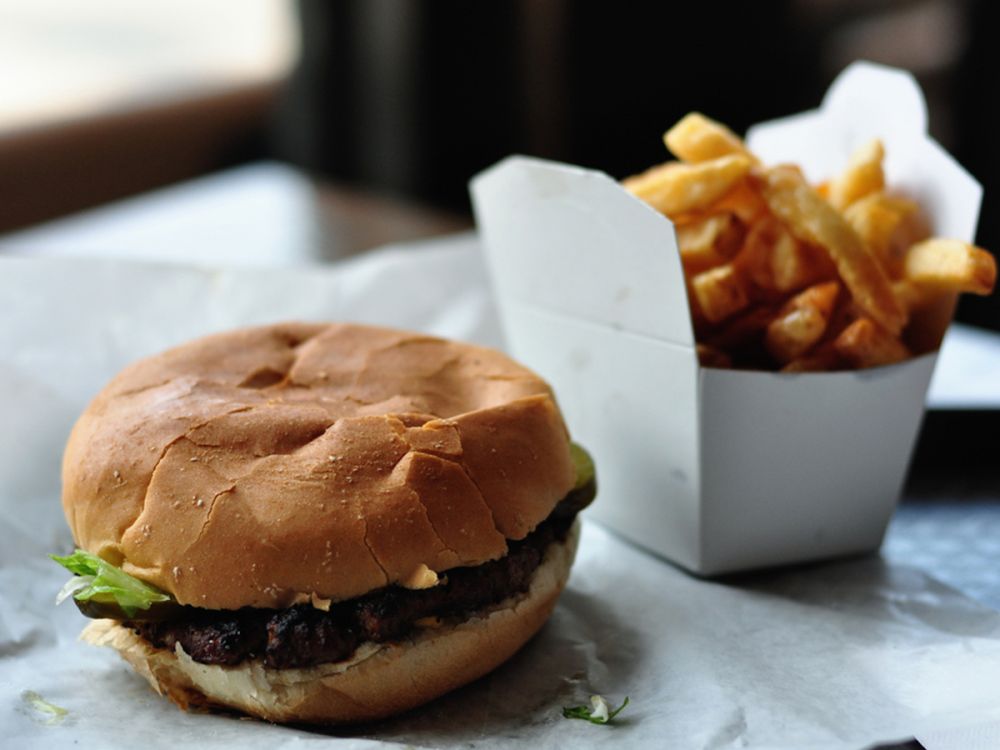 Beef burger in a patty, with chips
