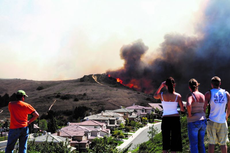 Residents overlooking a wildfire near their homes