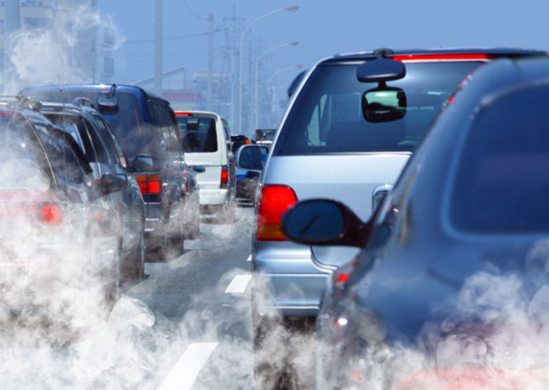 A queue of cars with excessive exhaust fumes