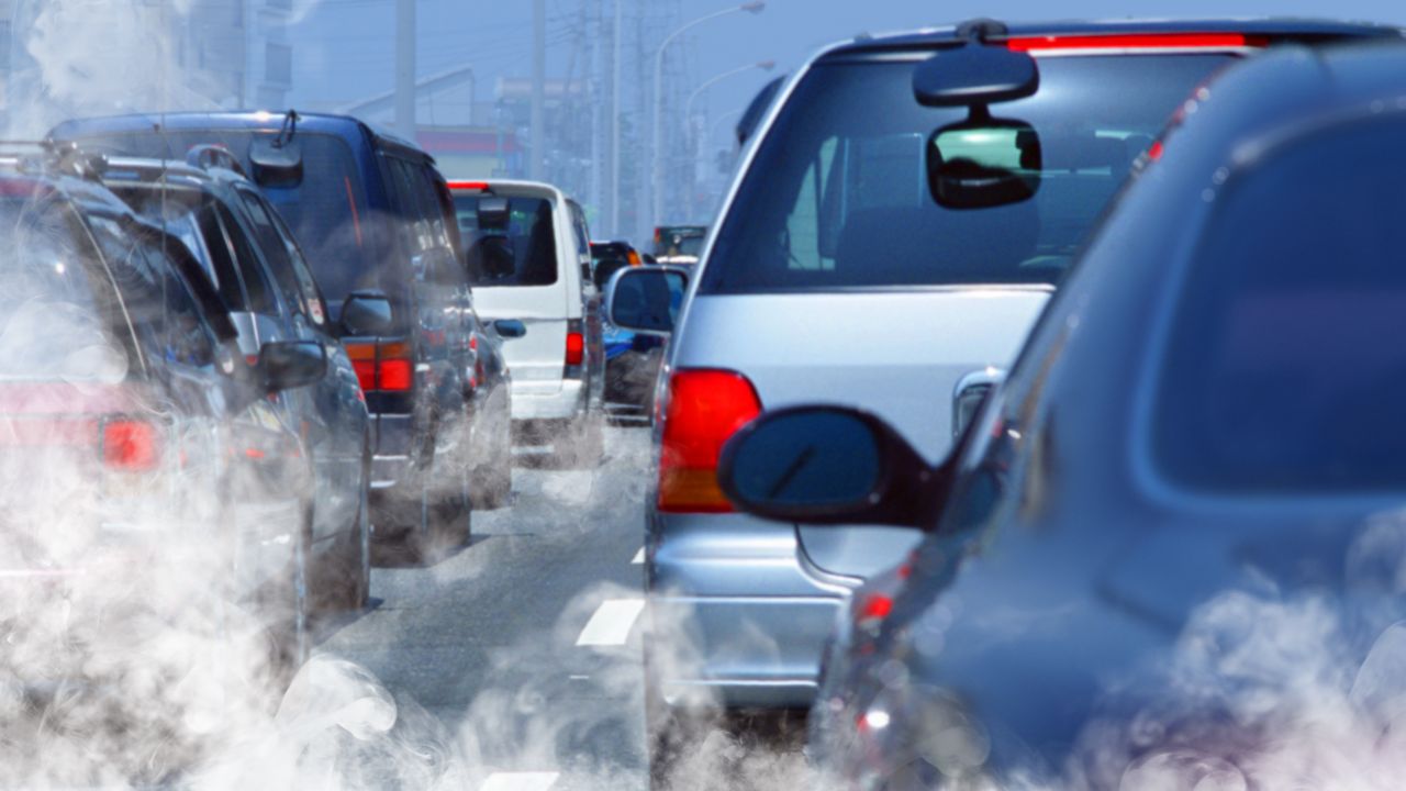 A queue of cars with excessive exhaust fumes