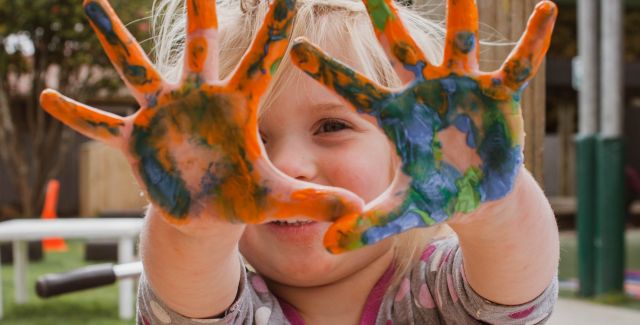 Child with paint on hands