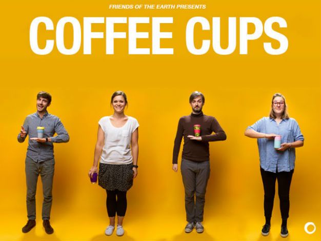 4 Friends of the Earth staff members posing with the reusable coffee mugs they have reviewed