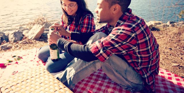 A couple enjoying a picnic on the beach