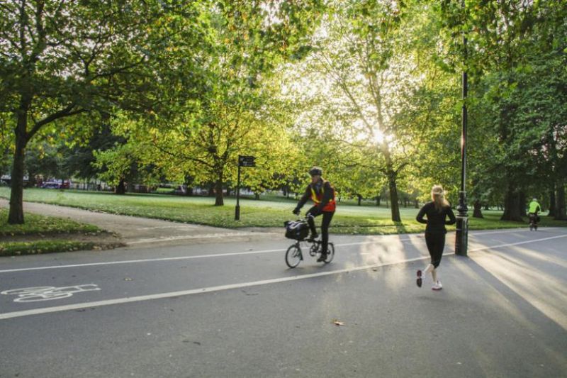 Cyclist and jogger in a park