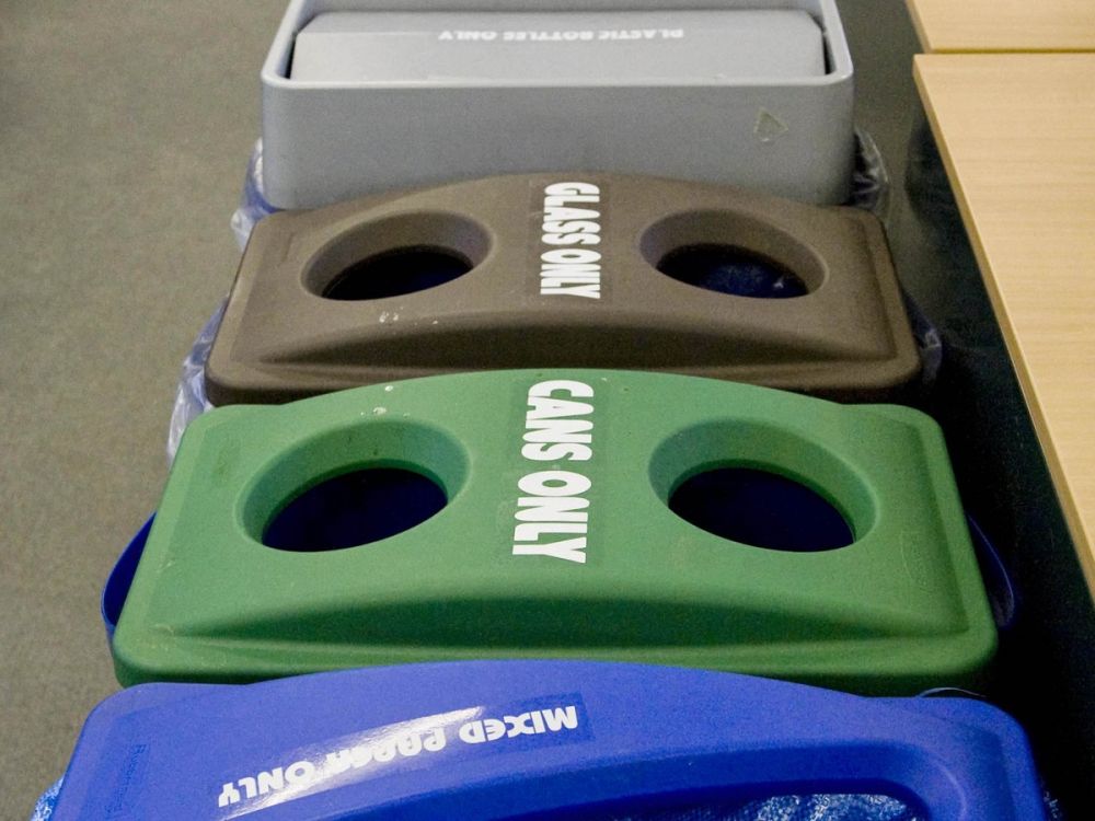 Recycling bins in a line in an office