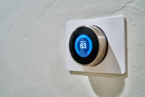 A thermostat showing that the temperature is 63