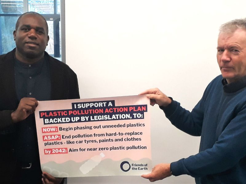 David Lammy, MP for Tottenham, holding a banner up with Quentin Given, Tottenham and Wood Green Friends of the Earth. The banner declares David's support for a plastics law to phase out non-essential plastics
