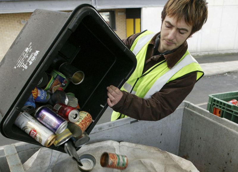 Worker collecting recycling, emptying bin