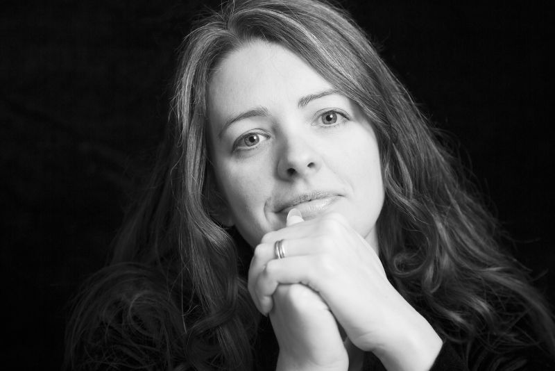 A black and white portrait photo of writer and podcaster Emma Newman