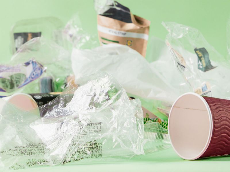 Examples of everyday plastic waste in our lives including disposable coffee cups and food packaging