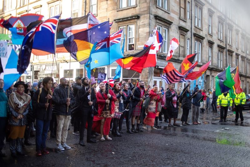 A crowd of people holding different countries flags.