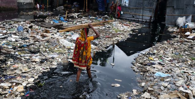 Woman in flooded street in Bangladesh