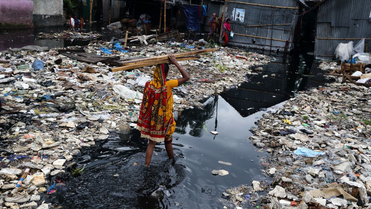 Woman in flooded street in Bangladesh