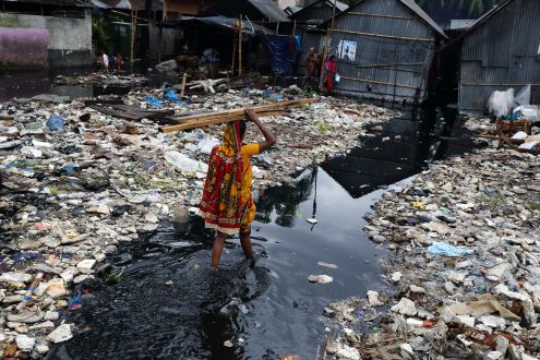 Woman in flooded street in Bangladesh