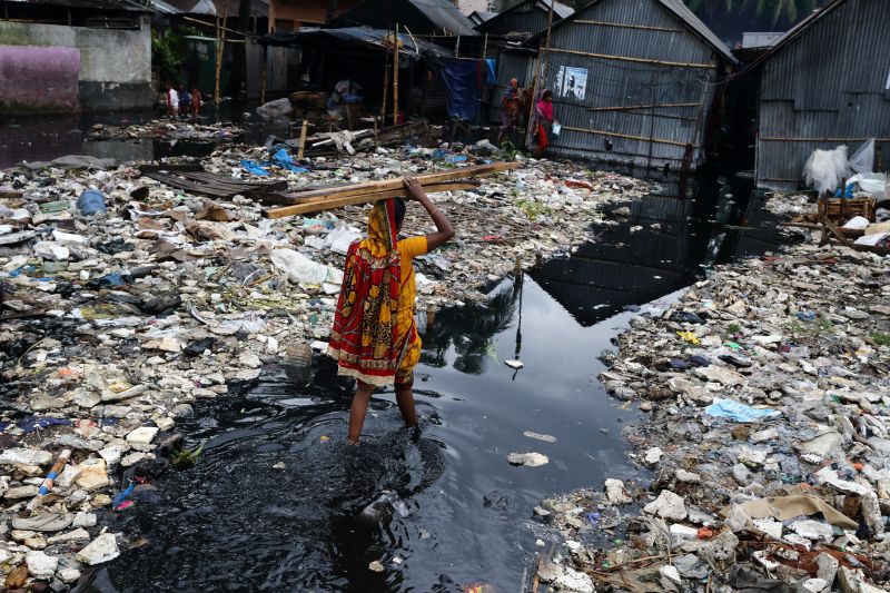 Woman in flooded street in Bangladesh