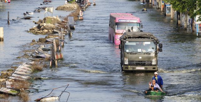 Flooding with bus and boats on road