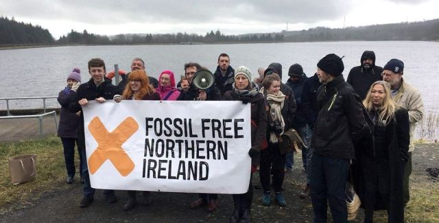 Campaigners holding a 'Fossil Free Northern Ireland' banner 