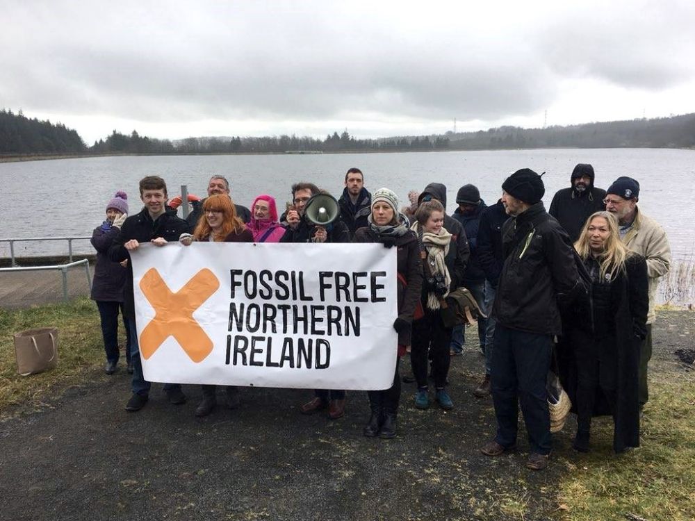 Campaigners holding a 'Fossil Free Northern Ireland' banner
