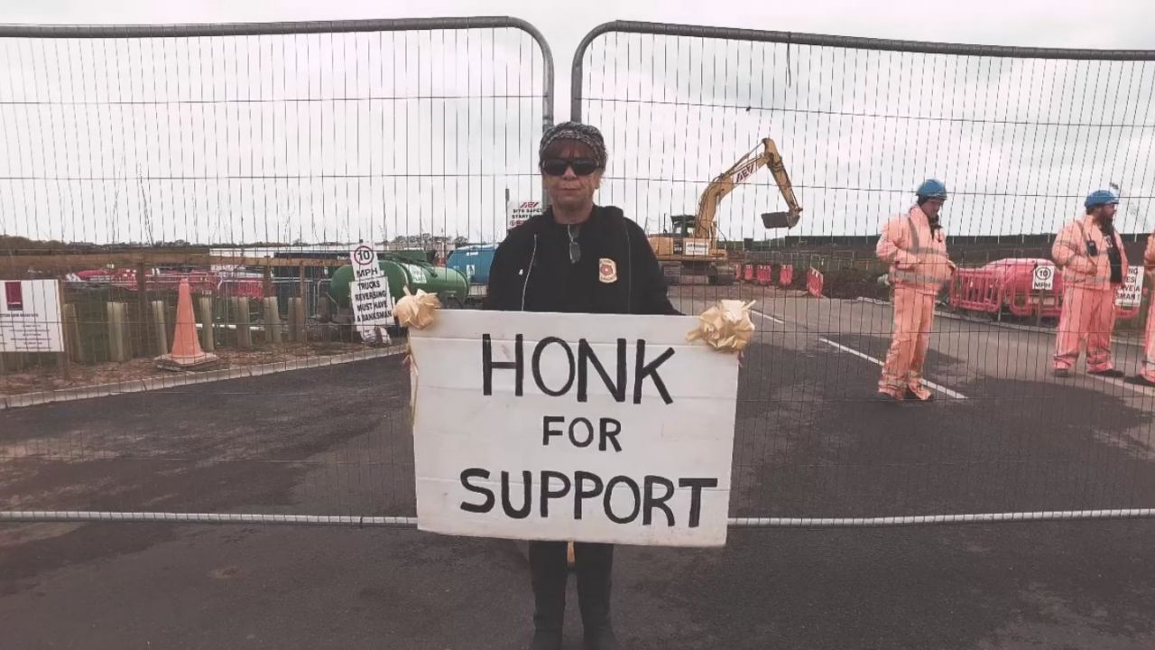 Protestor holding a "Honk for support" sign