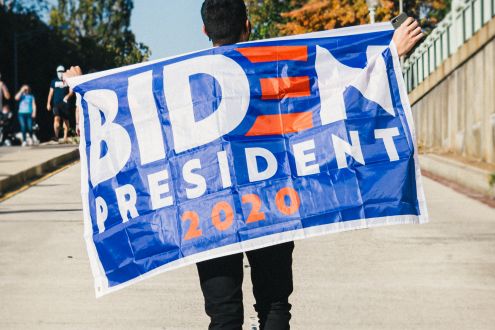 Person holding Biden President 2020 flag