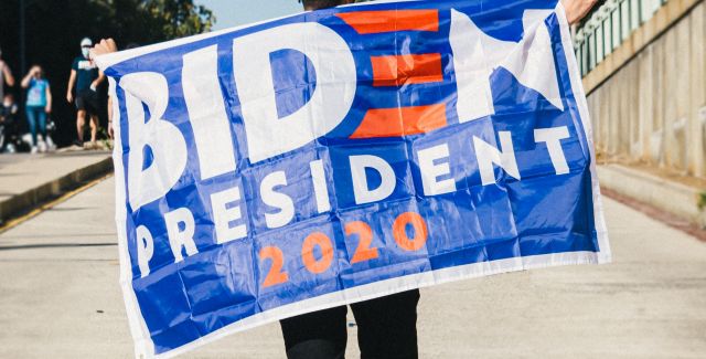 Person holding Biden President 2020 flag