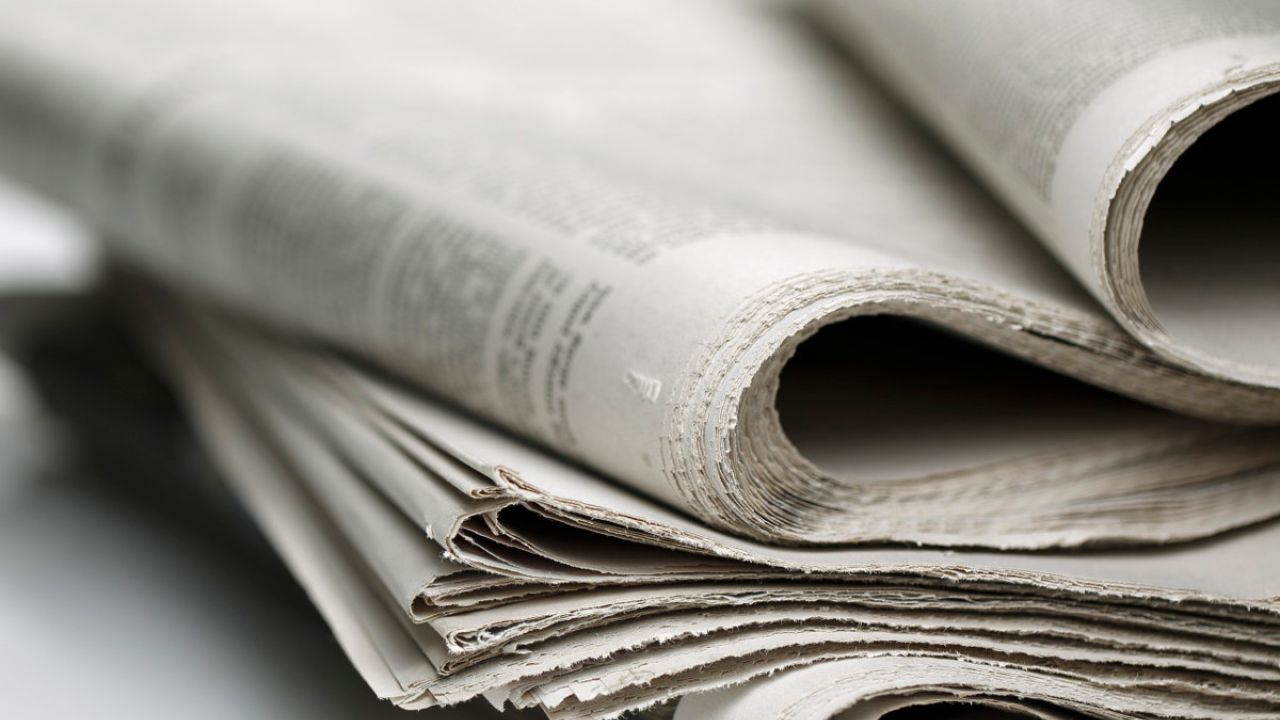 Shallow depth-of-field photo of a stack of newspapers