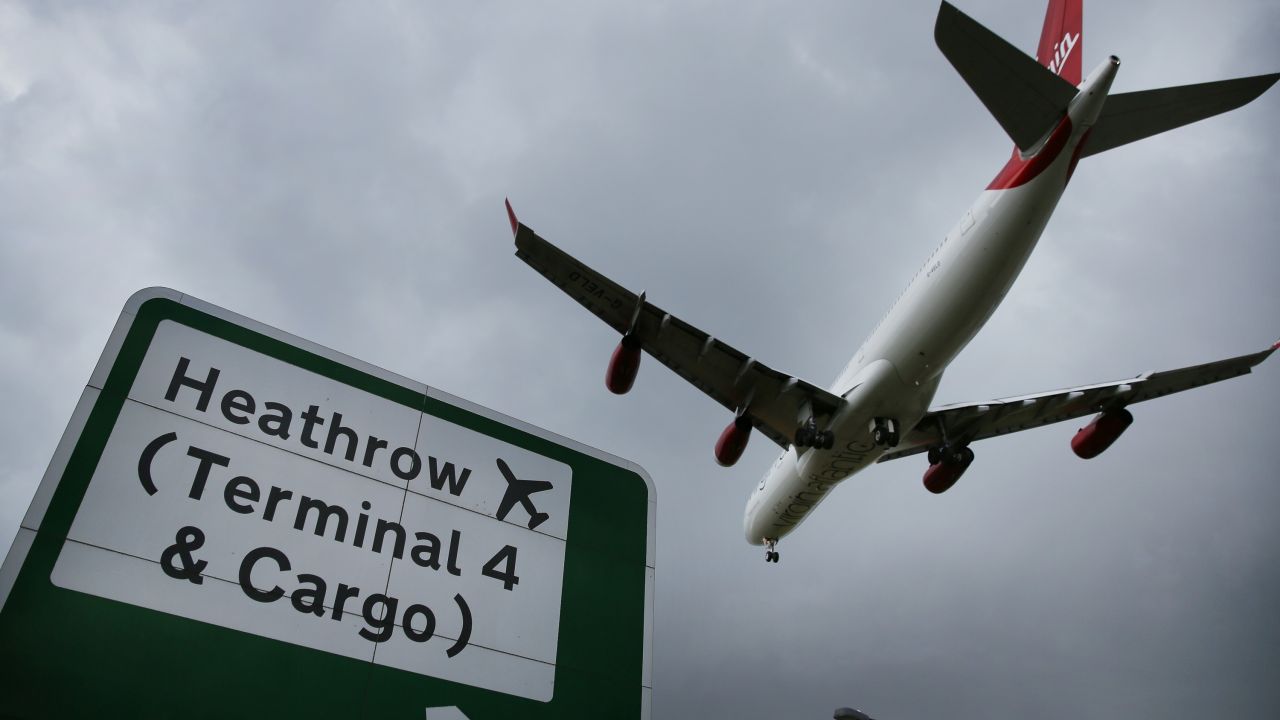 Airplane in the sky with a sign that says 'Heathrow (Terminal 4 & Cargo)'