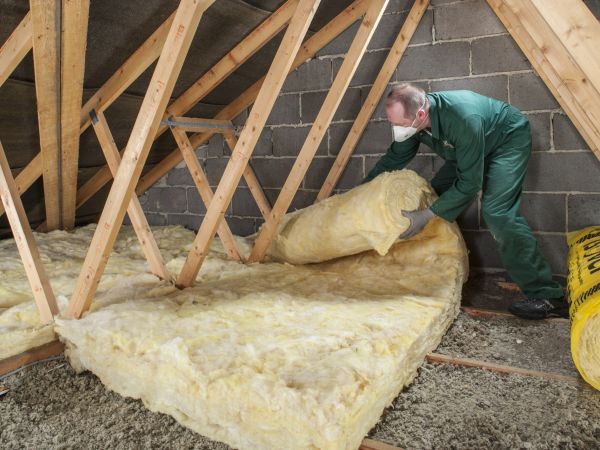 Man installing loft insulation