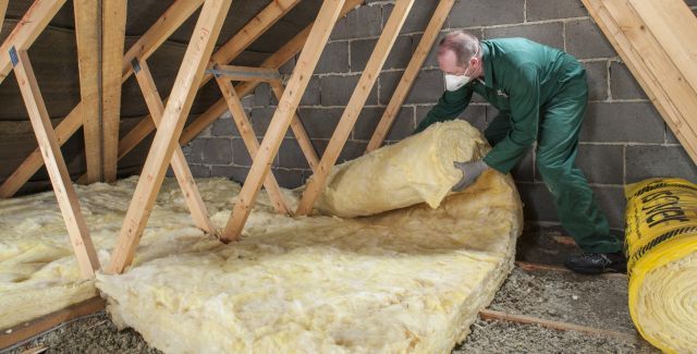 Man installing loft insulation