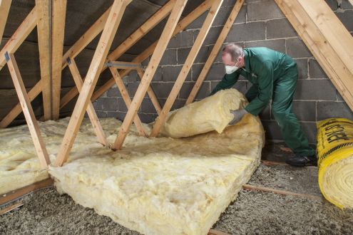 Man installing loft insulation