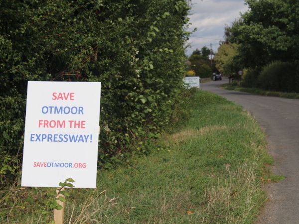 Save Otmoor sign on grass verge along country lane