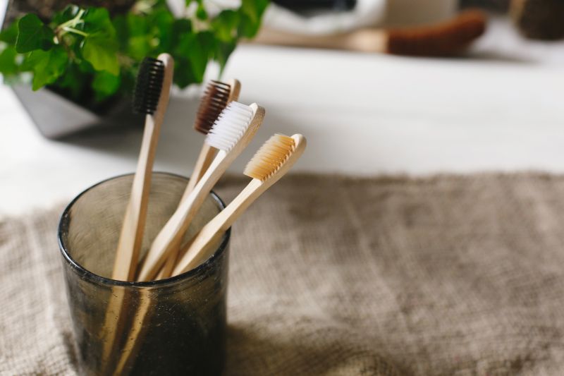 Bamboo toothbrushes in a glass jar