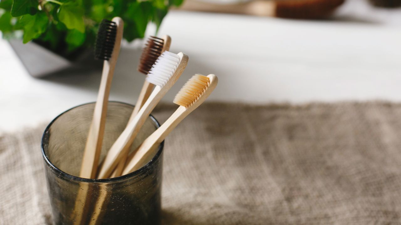 Bamboo toothbrushes in a glass jar