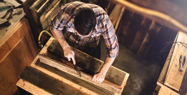 photo of man working with reclaimed wood